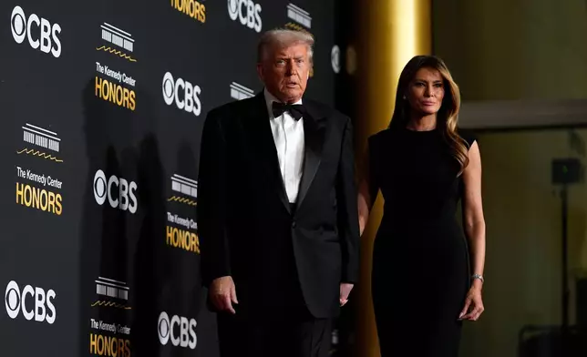 President Donald Trump and first lady Melania Trump, walk the red carpet before the 48th Kennedy Center Honors, Sunday, Dec. 7, 2025, at the John F. Kennedy Center for the Performing Arts in Washington. (AP Photo/Julia Demaree Nikhinson)