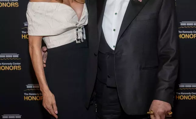 2025 Kennedy Center Honoree Sylvester Stallone, right, and Jennifer Flavin arrive on the red carpet for the 48th Kennedy Center Honors Medallion Reception, hosted at the U.S. Department of State, Saturday, Dec. 6, 2025 in Washington. (AP Photo/Kevin Wolf)