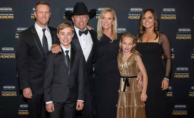 2025 Kennedy Center Honoree George Strait, center left, and his family arrive on the red carpet for the 48th Kennedy Center Honors Medallion Reception, hosted at the U.S. Department of State, Saturday, Dec. 6, 2025 in Washington. (AP Photo/Kevin Wolf)