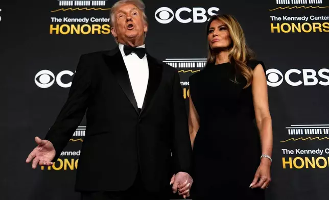 President Donald Trump and first lady Melania Trump, walk the red carpet before the 48th Kennedy Center Honors, Sunday, Dec. 7, 2025, at the John F. Kennedy Center for the Performing Arts in Washington. (AP Photo/Julia Demaree Nikhinson)
