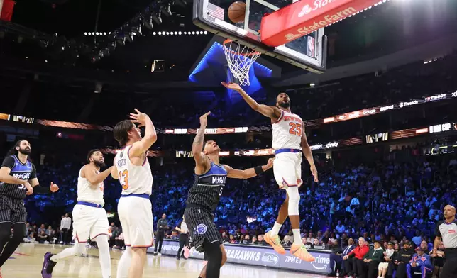 Orlando Magic forward Paolo Banchero (5) shoots the ball near New York Knicks guard Mikal Bridges (25) in the second half of an NBA Cup semifinals basketball game, Saturday, Dec. 13, 2025, in Las Vegas. (AP Photo/Ronda Churchill)