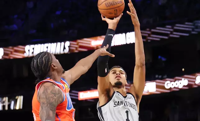 San Antonio Spurs forward Victor Wembanyama (1) shoots the ball near Oklahoma City Thunder guard Jalen Williams (8) in the second half of an NBA Cup semifinals basketball game, Saturday, Dec. 13, 2025, in Las Vegas. (AP Photo/Ronda Churchill)
