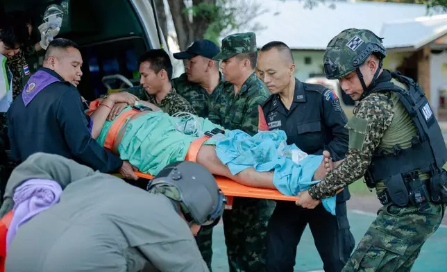 In this photo released by Royal Thai Army, a wounded Thai soldier is carried to be transferred to a hospital in Sisaket province, Thailand, Sunday, Dec. 7, 2025, after, according to a Thai army spokesperson, Cambodian troops fired into Thai territory. (Royal Thai Army via AP)