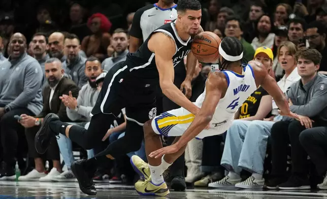 Brooklyn Nets' Michael Porter Jr. (17) collides with Golden State Warriors' Moses Moody (4) during the first half of an NBA basketball game Monday, Dec. 29, 2025, in New York. (AP Photo/Frank Franklin II)