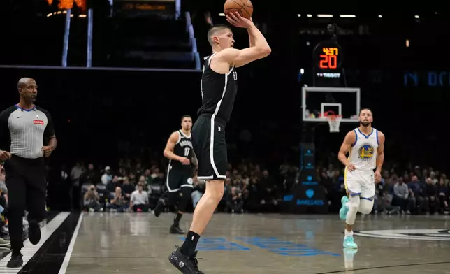 Brooklyn Nets' Egor Demin (8) shoots over Golden State Warriors' Stephen Curry (30) during the first half of an NBA basketball game Monday, Dec. 29, 2025, in New York. (AP Photo/Frank Franklin II)