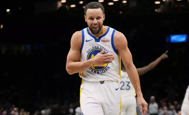 Golden State Warriors' Stephen Curry gestures after making a three-point shot during the first half of an NBA basketball game against the Brooklyn Nets Monday, Dec. 29, 2025, in New York. (AP Photo/Frank Franklin II)
