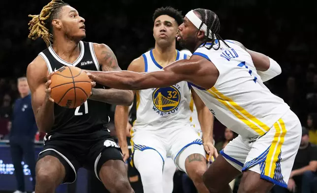 Golden State Warriors' Will Richard (3) defends Brooklyn Nets' Noah Clowney (21) during the first half of an NBA basketball game Monday, Dec. 29, 2025, in New York. (AP Photo/Frank Franklin II)