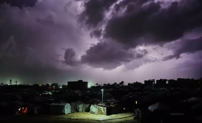 A thunderstorm is seen over a tent camp for displaced Palestinians in Zawaida, central Gaza Strip, Wednesday, Dec. 10, 2025. (AP Photo/Abdel Kareem Hana)