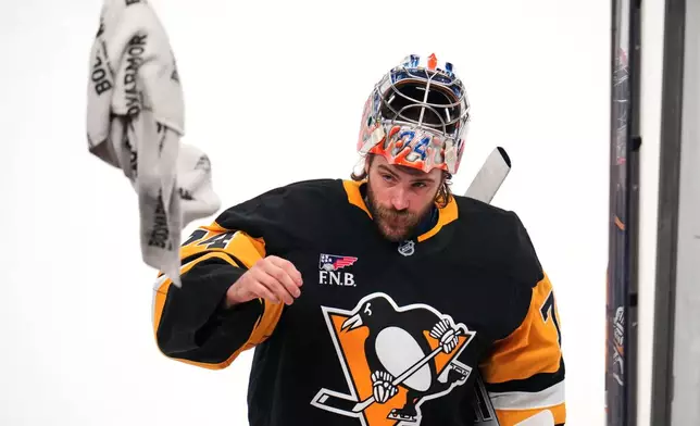 Pittsburgh Penguins goalie Stuart Skinner tosses a towel during a first period timeout in an NHL hockey game against the Edmonton Oilers, in Pittsburgh, Tuesday, Dec. 16, 2025. (AP Photo/Gene J. Puskar)