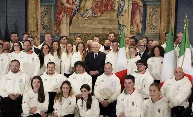 Italian President Sergio Mattarella, center, poses for a group photo with Olympic and Paralympic athletes during the hand over ceremony of the Italian flag for the Milan-Cortina Winter Olympic games, at the Quirinale Presidential palace, in Rome, Monday, Dec. 22, 2025. (AP Photo/Gregorio Borgia)
