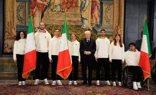 From left, Italian athletes Federica Brignone, Amos Mosaner, Federico Pellegrino, Arianna Fontana, Italian President Sergio Mattarella, Rene' de Silvestro, right, and Chiara Mazzel, second from right, pose for a group photo, during the hand over ceremony of the Italian flag for the Milan-Cortina Winter Olympic games, at the Quirinale Presidential palace, in Rome, Monday, Dec. 22, 2025. (AP Photo/Gregorio Borgia)