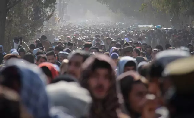 A crowd leaves a stadium after attending the public execution, carried out by Taliban authorities, of a man sentenced by the Supreme Court for killing 13 members of a family, including children, earlier this year, in the eastern city of Khost, Afghanistan, Tuesday, Dec. 2, 2025. (AP Photo/Saifullah Zahir)