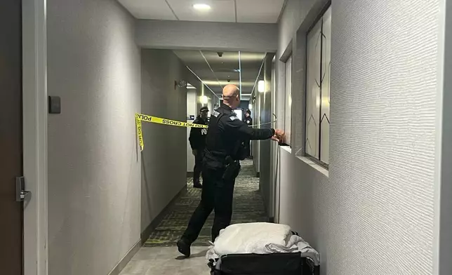 Police tape off hotel rooms where the person of interest was arrested in a shooting in Coventry, RI., (AP Photo/Kimberlee Kruesi)