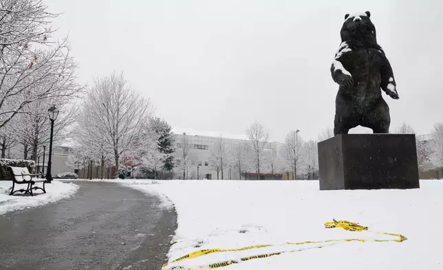 Police caution tape lays askew at Brown University's Ittleson Quad Sunday, Dec. 14, 2025, after a shooting on Saturday in Providence, R.I. (Lily Speredelozzi/The Sun Chronicle via AP)