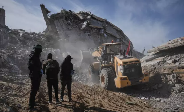 Islamic Jihad and Hamas militants search for the remains of deceased hostages in Beit Lahiya, northern Gaza Strip Wednesday, Dec. 3, 2025. (AP Photo/Jehad Alshrafi)