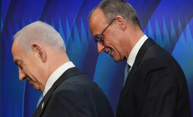 Israeli Prime Minister Benjamin Netanyahu, left, and German Chancellor Friedrich Merz leave the podium following a joint press conference in Jerusalem Sunday, Dec. 7, 2025. (AP Photo/Ariel Schalit, Pool)
