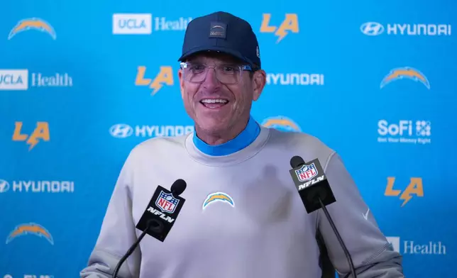 Los Angeles Chargers head coach Jim Harbaugh speaks during a news conference following an NFL football game against the Kansas City Chiefs Sunday, Dec. 14, 2025, in Kansas City, Mo. (AP Photo/Ed Zurga)