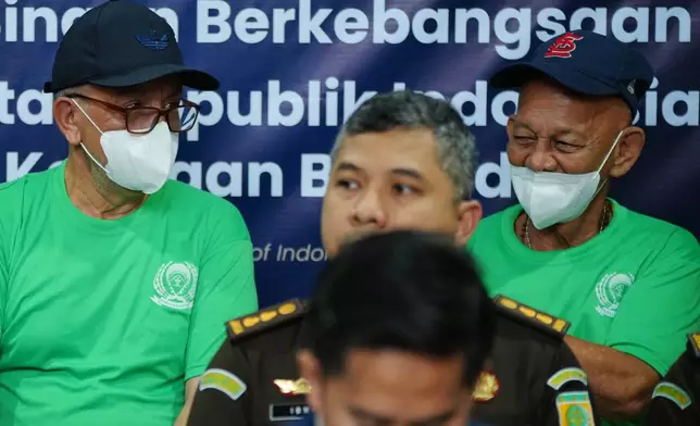 Dutch nationals facing death row Siegfried Mets, right, and serving life in prison, Ali Tokman, left, attend the handover ceremony between the representatives of Indonesian and Dutch government before their repatriation to the Netherlands, at Cipinang Prison in Jakarta, Indonesia, Monday, Dec. 8, 2025. (AP Photo/Tatan Syuflana)