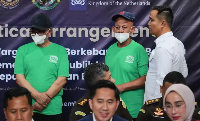 Dutch nationals facing death row Siegfried Mets, right, and serving life in prison, Ali Tokman, left, attend the handover ceremony between the representatives of Indonesian and Dutch government before their repatriation to the Netherlands, at Cipinang Prison in Jakarta, Indonesia, Monday, Dec. 8, 2025. (AP Photo/Tatan Syuflana)
