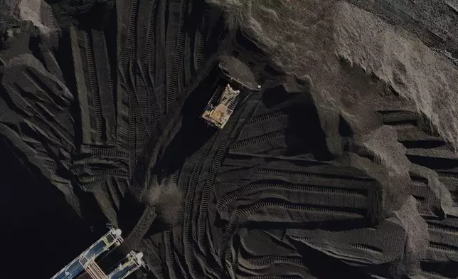 FILE - A bulldozer moves coal April 10, 2025, in Princeton, Ind. (AP Photo/Joshua A. Bickel, File)