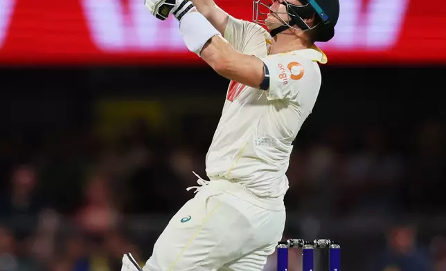 Australia's captain Steve Smith hits a six during the second Ashes cricket test match between Australia and England in Brisbane, Friday, Dec. 5, 2025.. (AP Photo/Tertius Pickard)