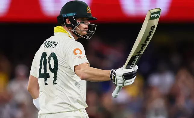 Australia's captain Steve Smith celebrates his fifty runs during the second Ashes cricket test match between Australia and England in Brisbane, Friday, Dec. 5, 2025.. (AP Photo/Tertius Pickard)