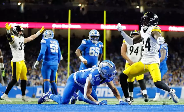 Pittsburgh Steelers' Joey Porter Jr. (24) reacts after breaking up a pass for Detroit Lions' Amon-Ra St. Brown (14) in the endzone during the first half of an NFL football game, Sunday, Dec. 21, 2025, in Detroit. (AP Photo/Rey Del Rio)