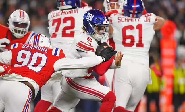 New York Giants quarterback Jaxson Dart (6) runs against New England Patriots defensive tackle Christian Barmore (90) during the first half of an NFL football game, Monday, Dec. 1, 2025, in Foxborough, Mass. (AP Photo/Steven Senne)