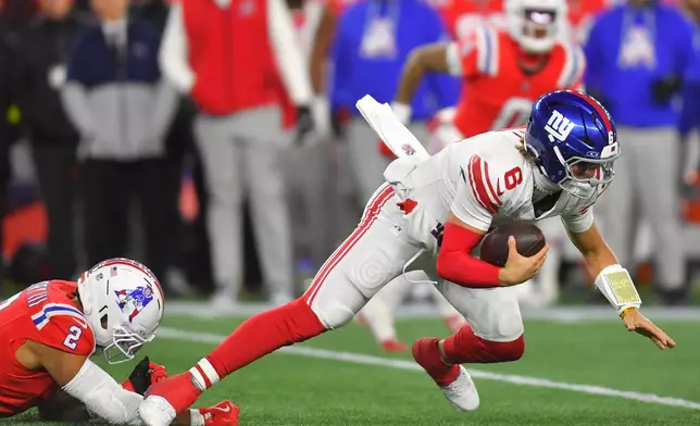 New York Giants quarterback Jaxson Dart (6) is sacked by New England Patriots linebacker Harold Landry III (2) during the second half of an NFL football game Monday, Dec. 1, 2025, in Foxborough, Mass. (AP Photo/Steven Senne)