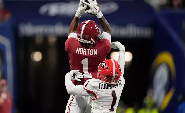 Alabama wide receiver Isaiah Horton (1) misses the catch against Georgia defensive back Ellis Robinson IV (1) during the first half of a Southeastern Conference championship NCAA college football game, Saturday, Dec. 6, 2025, in Atlanta. (AP Photo/Mike Stewart)
