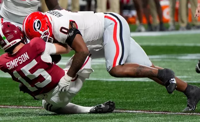 Georgia linebacker Gabe Harris Jr. (0) hits Alabama quarterback Ty Simpson (15) during the first half of a Southeastern Conference championship NCAA college football game, Saturday, Dec. 6, 2025, in Atlanta. (AP Photo/Mike Stewart)