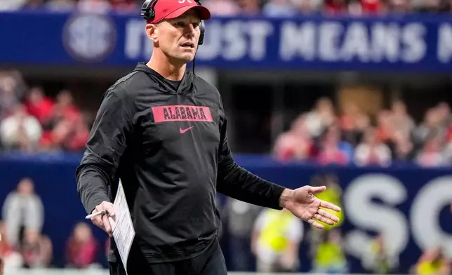 Alabama head coach Kalen Deboer speaks to an official during the first half of a Southeastern Conference championship NCAA college football game between Georgia and Alabama, Saturday, Dec. 6, 2025, in Atlanta. (AP Photo/Mike Stewart)