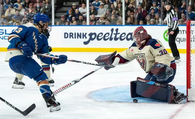 Montreal Victoire goaltender Sandra Abstreiter (30) stops Vancouver Goldeneyes' Tereza Vanišová during the third period of a PWHL hockey game in Vancouver, British Columbia, Saturday, Dec. 20, 2025. (Ethan Cairns/The Canadian Press via AP)