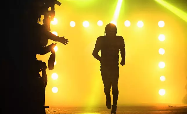 Pittsburgh Steelers quarterback Aaron Rodgers jogs onto the field during introductions before the first half of an NFL football game against the Miami Dolphins in Pittsburgh, Monday, Dec. 15, 2025. (AP Photo/Justin Berl)