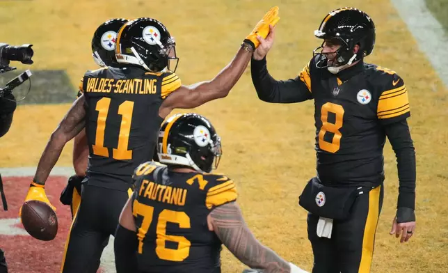 Pittsburgh Steelers' Marquez Valdes-Scantling (11), Aaron Rodgers (8) and Troy Fautanu (76) celebrate after Marquez Valdes-Scantling caught a touchdown pass in the second half of an NFL football game against the Miami Dolphins in Pittsburgh, Monday, Dec. 15, 2025. (AP Photo/Gene J. Puskar)