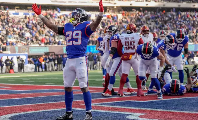 New York Giants running back Tyrone Tracy Jr. (29) reacts after scoring a touchdown against the Washington Commanders during the second quarter of an NFL football game, Sunday, Dec. 14, 2025, in East Rutherford, N.J. (AP Photo/Yuki Iwamura)