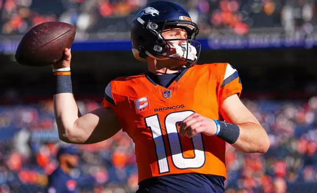 Denver Broncos' Bo Nix warms up before an NFL football game against the Green Bay PackersSunday, Dec. 14, 2025, in Denver. (AP Photo/Jack Dempsey)