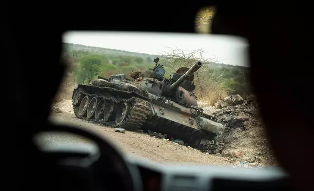 FILE - A destroyed tank is seen by the side of the road south of Humera, in an area of western Tigray, annexed by the Amhara region during the ongoing conflict, in Ethiopia, May 1, 2021. (AP Photo/Ben Curtis, File)