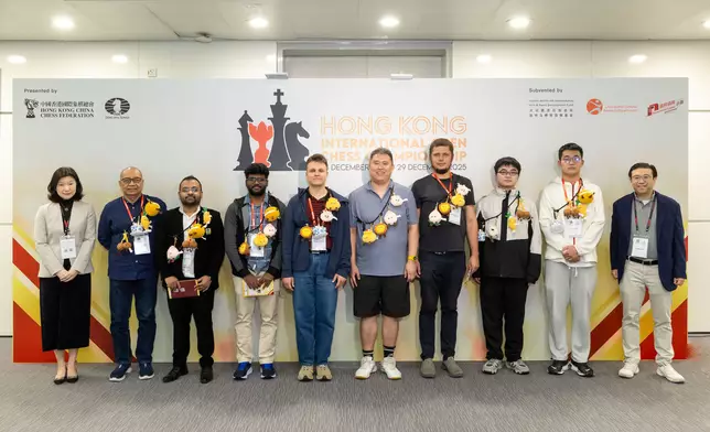 From left to right: Ms. Shen Chenyi, Vice President of the Hong Kong China Chess Federation, Buenaventura Villamayor (Singapore), Abhijeet Gupta (India), N R Visakh (India), Maxim Vavulin (Germany), Zhao Zong-Yuan (Australia), Jacek Stopa (Poland), Peng Xiongjian (China), Pang Tao (China) and Mr. Geoffrey Kao, Honorary President of the Hong Kong China Chess Federation.