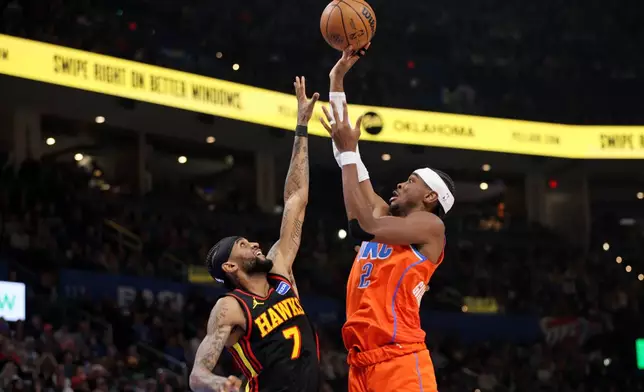 Oklahoma City Thunder guard Shai Gilgeous-Alexander (2) shoots over Atlanta Hawks guard Nickeil Alexander-Walker (7) during the second half of an NBA basketball game Monday, Dec. 29, 2025, in Oklahoma City. (AP Photo/Nate Billings)