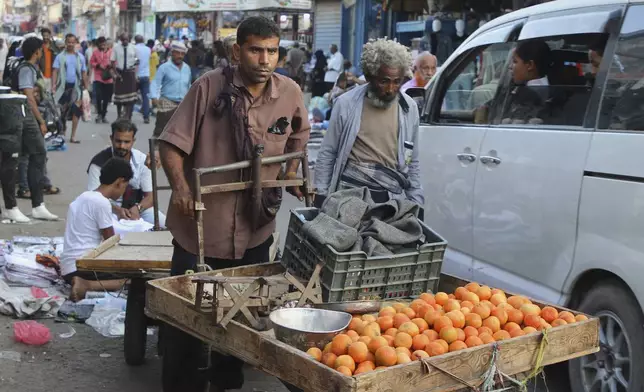 A street vender rides his cart at along a street in Aden, Yemen, Friday, Dec. 26, 2025. (AP Photo)