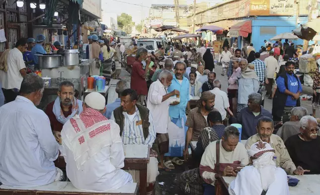 People eat at a restaurant in Aden, Yemen, Friday, Dec. 26, 2025. (AP Photo)