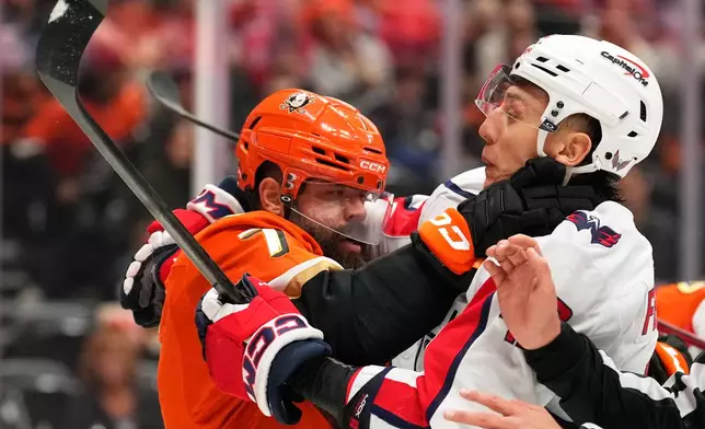 Anaheim Ducks defenseman Radko Gudas, left, and Washington Capitals defenseman Martin Fehérváry scuffle during the second period of an NHL hockey game Friday, Dec. 5, 2025, in Anaheim, Calif. (AP Photo/Mark J. Terrill)