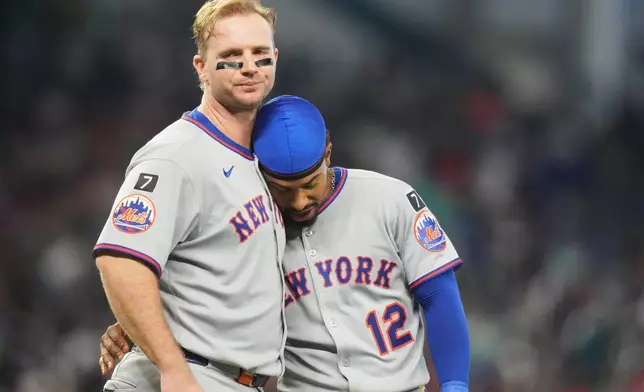 FILE - New York Mets' Pete Alonso, left, stands with Francisco Lindor after flying out with the bases loaded during the fifth inning of a baseball game against the Miami Marlins, Sunday, Sept. 28, 2025, in Miami. (AP Photo/Lynne Sladky, File)