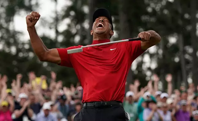 FILE - Tiger Woods reacts as he wins the Masters golf tournament, Sunday, April 14, 2019, in Augusta, Ga. (AP Photo/David J. Phillip, File)