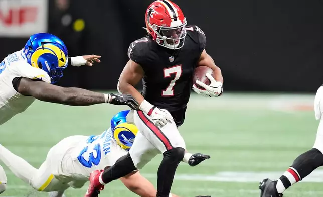 Atlanta Falcons running back Bijan Robinson (7) carries against the Los Angeles Rams in the second half of an NFL football game, Monday, Dec. 29, 2025, in Atlanta. (AP Photo/Mike Stewart)