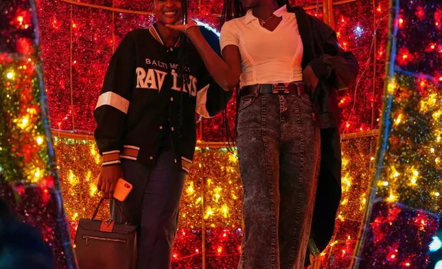 FILE - People take a photo inside a Christmas light installation, in Dakar, Senegal, Monday, Dec. 15, 2025. (AP Photo/Misper Apawu, File)