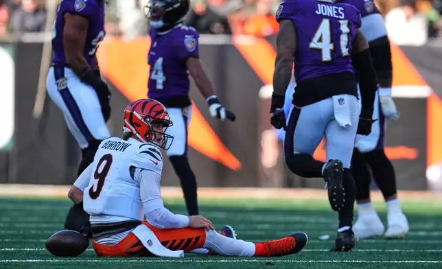 Cincinnati Bengals quarterback Joe Burrow (9) reacts after being sacked by Baltimore Ravens linebacker Tavius Robinson during the first half of an NFL football game, Sunday, Dec. 14, 2025, in Cincinnati. (AP Photo/Jeff Dean)