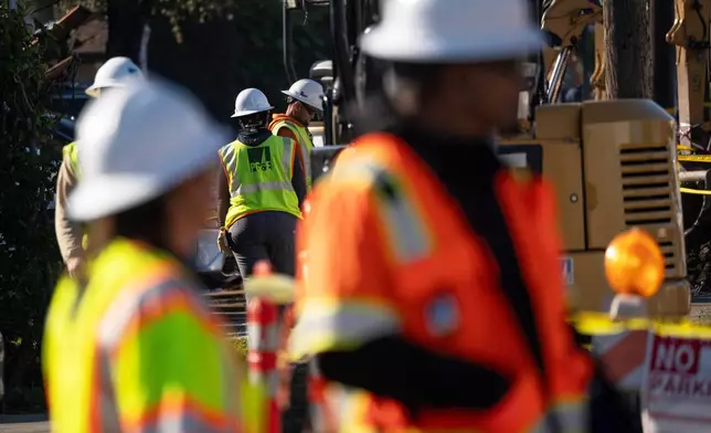 First responders and Pacific Gas &amp; Electric Co. workers at the site of a gas explosion in a neighborhood, Thursday, Dec. 11, 2025, in Hayward, Calif. (AP Photo/Minh Connors)