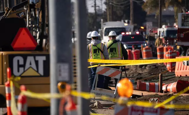First responders and Pacific Gas &amp; Electric Co workers at the site of the explosion on the 800 block of East Lewelling Boulevard, Thursday, Dec. 11, 2025, in Hayward, Calif. (AP Photo/Minh Connors)